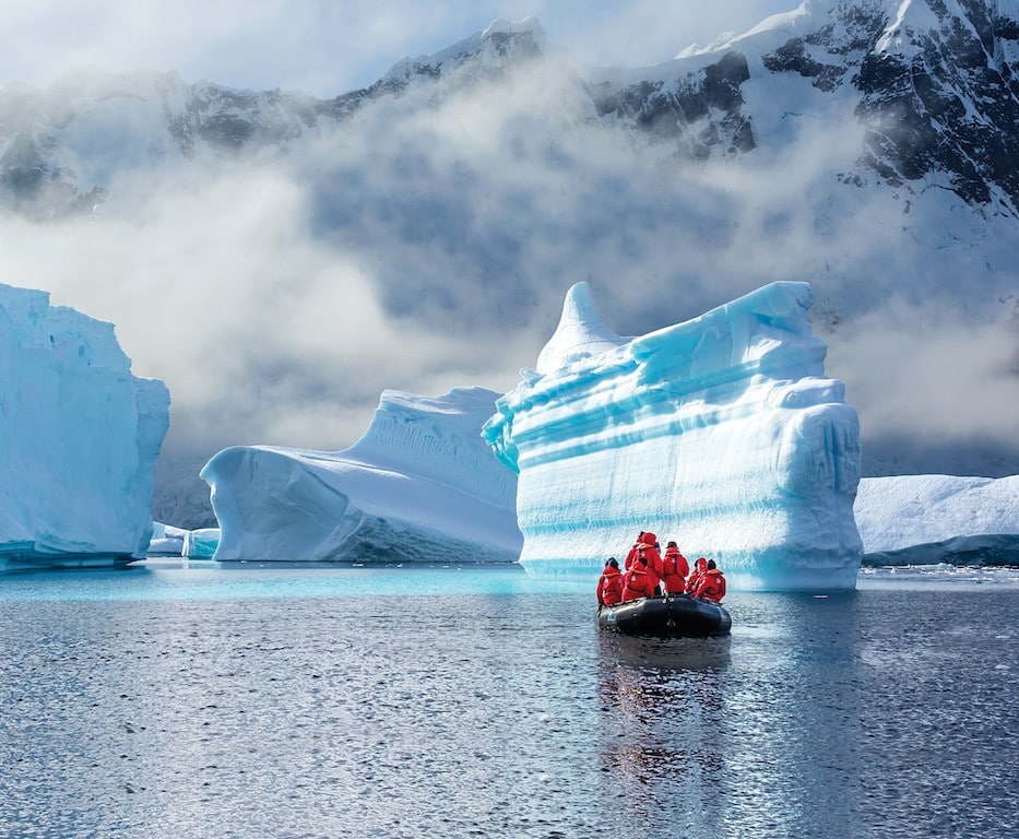 Guests from the Lindblad Expedition ship National Geographic Explorer enjoy icebergs at Booth Island, travel to Antarctica by Zodiac