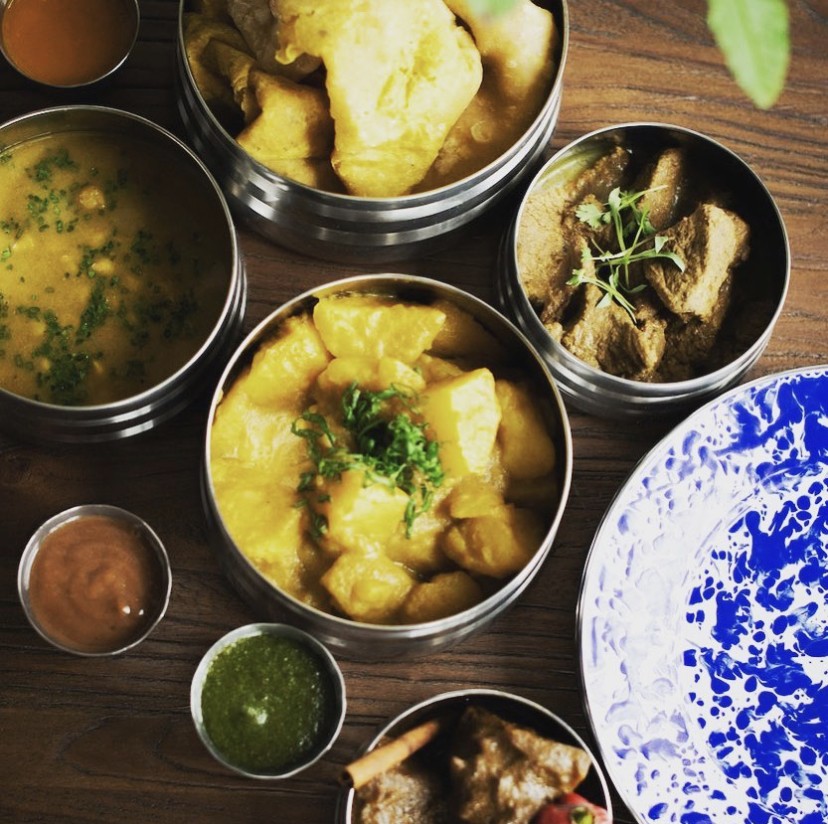 Omnivore and herbivore Curries in tiffin boxes at Cane