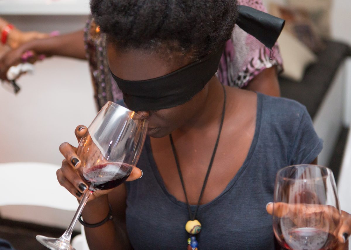 Woman blind tasting wine at an event at Sai Wine and Champagne Café in Ghana
