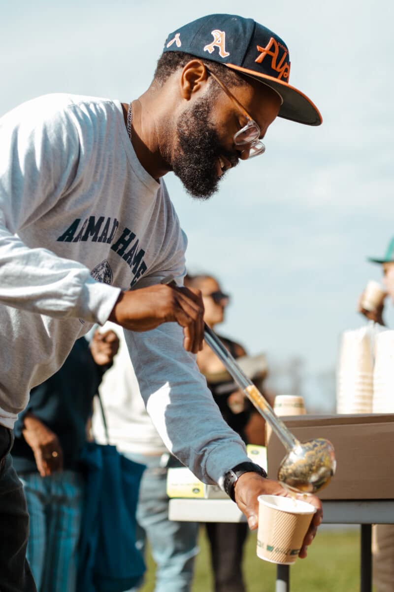 Denzel serves chili at the Garlic Planting & Fall Festival 