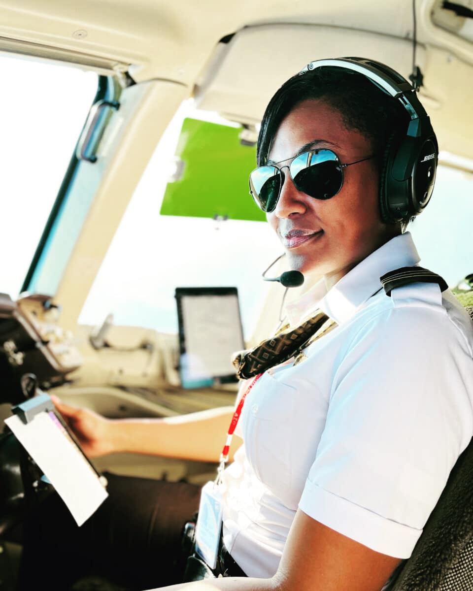 Sisters of the Skies co-founder Angela Hughes Angel Hughes in the cockpit of a plane preparing to fly 