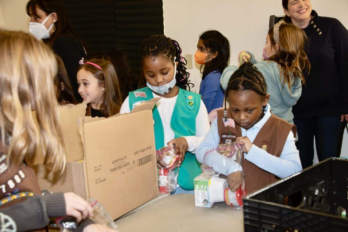 Center for Food Action -Englewood Girl Scouts assembling weekend snack packs