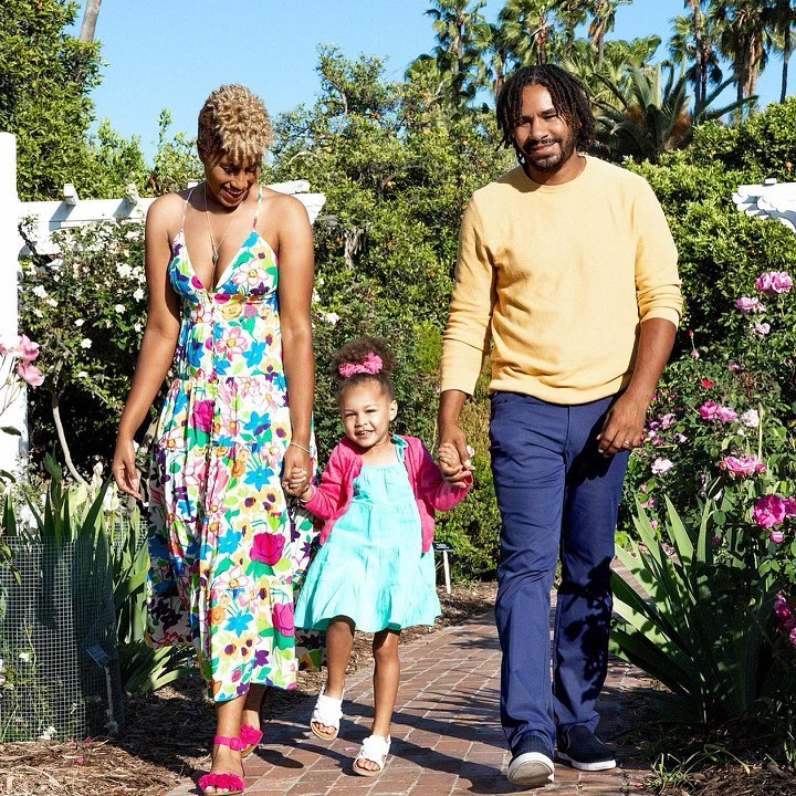 Michael Reed with wife Kwini and daugther Mackenzie walking through a garden