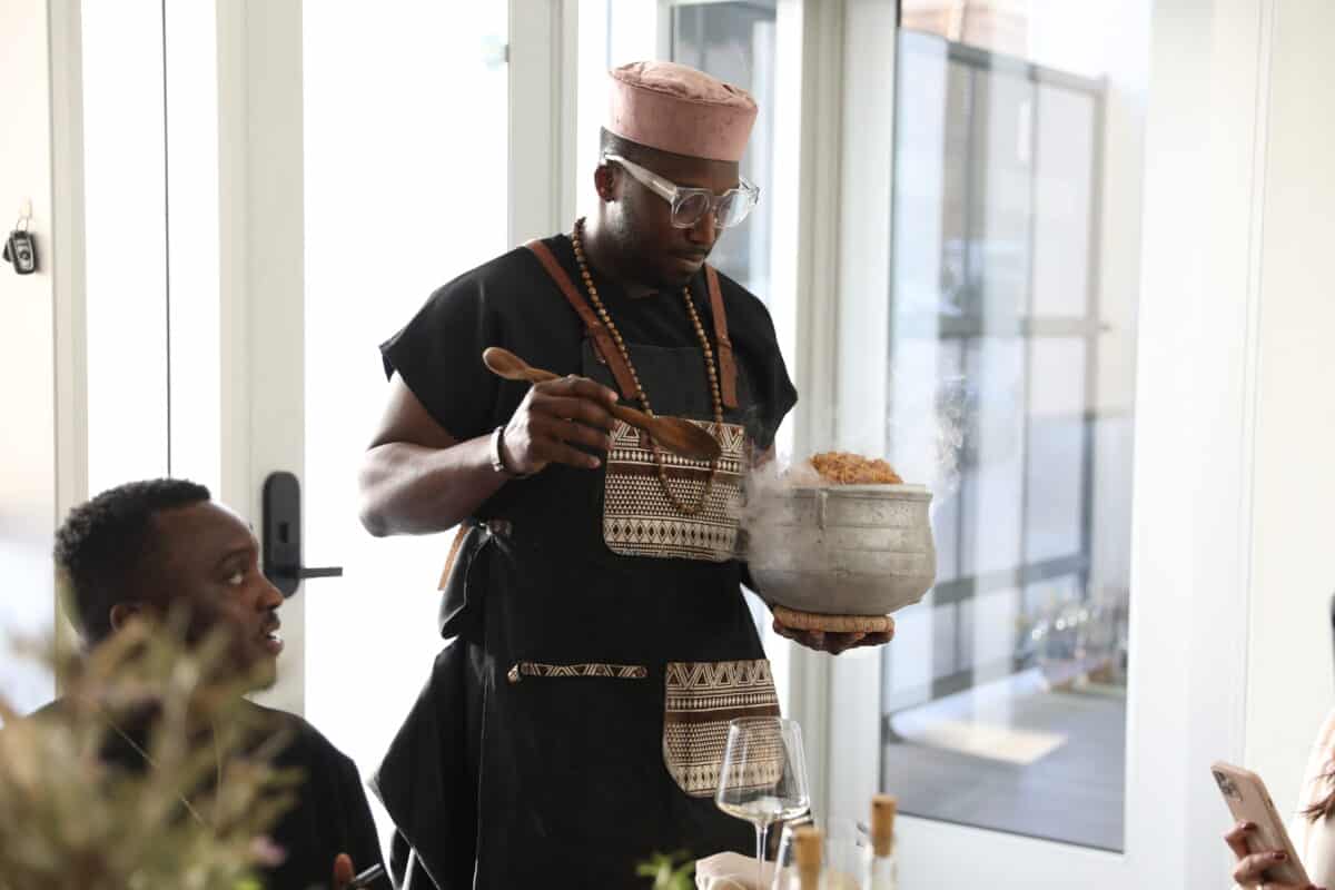 Chef Eros serving jollof rice during private dining experience