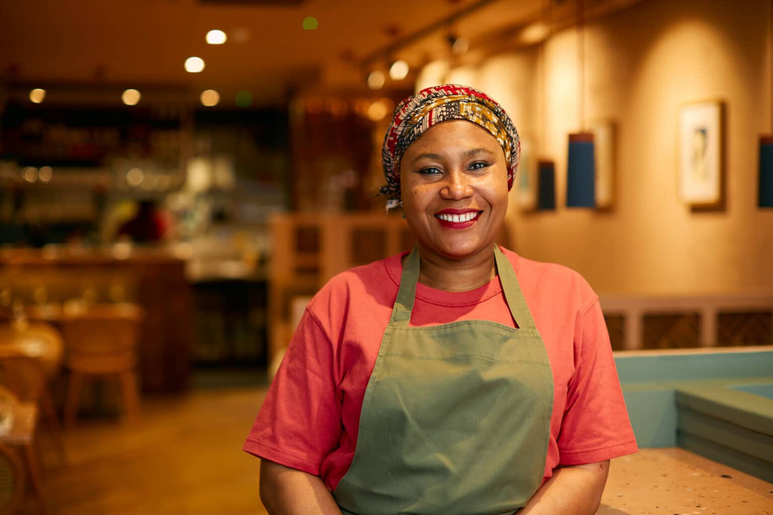 Chef and founder Adejoké Bakare standing in her restaurant Chishuru
